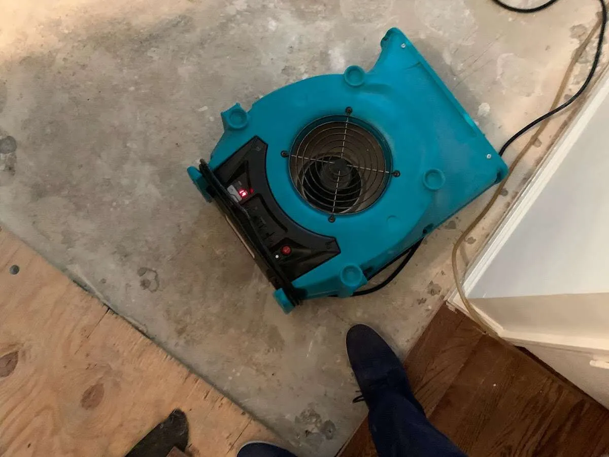 Air mover drying subfloor during Commercial Water Damage Restoration in Vernal